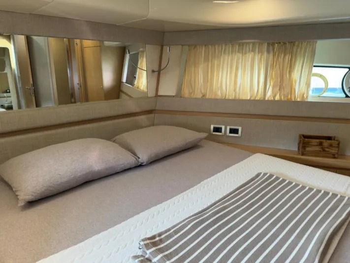  Yacht Photos Pics Luxurious bedroom interior of 2011 Ferretti Yachts 570 with cozy bedding and elegant decor.
