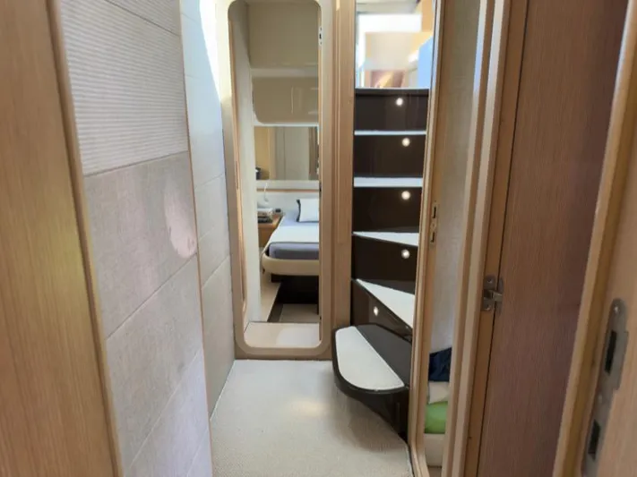  Yacht Photos Pics Interior of 2011 Ferretti Yachts 570, featuring modern staircase and cozy bedroom.