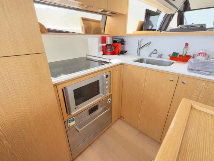  Yacht Photos Pics Modern kitchen in 2011 Ferretti Yachts 570 with microwave, sink, and coffee maker.