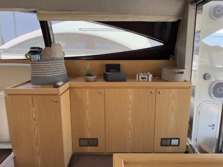  Yacht Photos Pics Interior of 2011 Ferretti Yachts 570 with wooden cabinetry and decorative items.