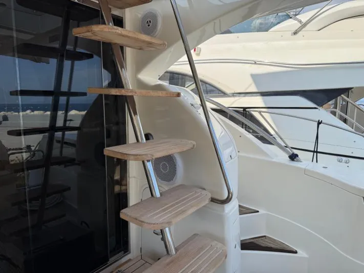  Yacht Photos Pics Staircase on a 2011 Ferretti Yachts 570, showcasing sleek design and craftsmanship.