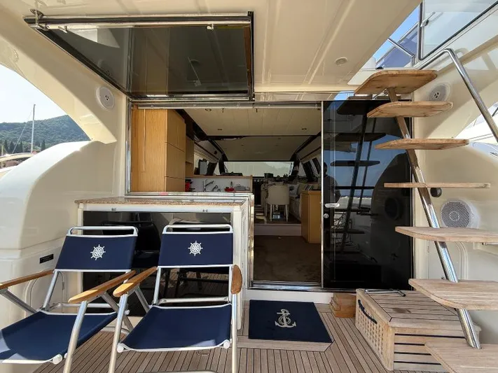  Yacht Photos Pics Luxurious 2011 Ferretti Yachts 570 interior with elegant seating and wooden staircase.