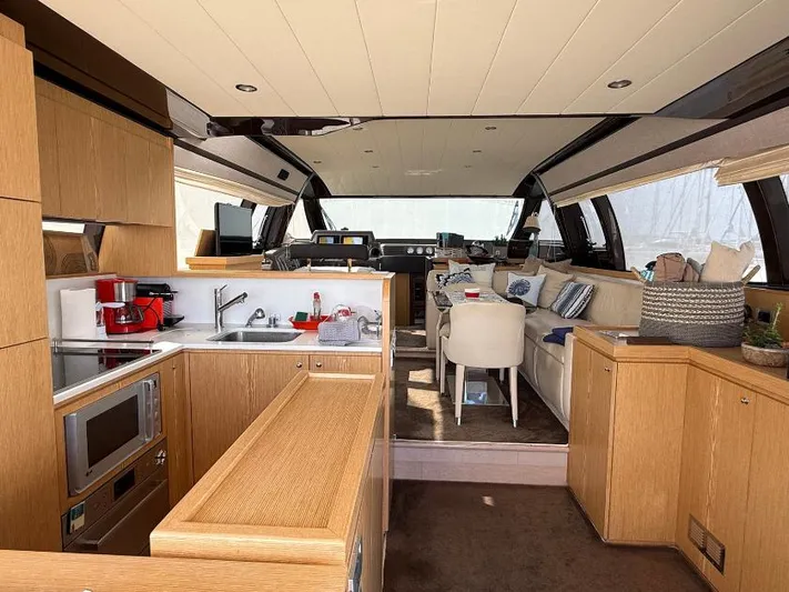  Yacht Photos Pics Luxurious interior of a 2011 Ferretti Yachts 570, featuring a modern kitchen and cozy seating area.