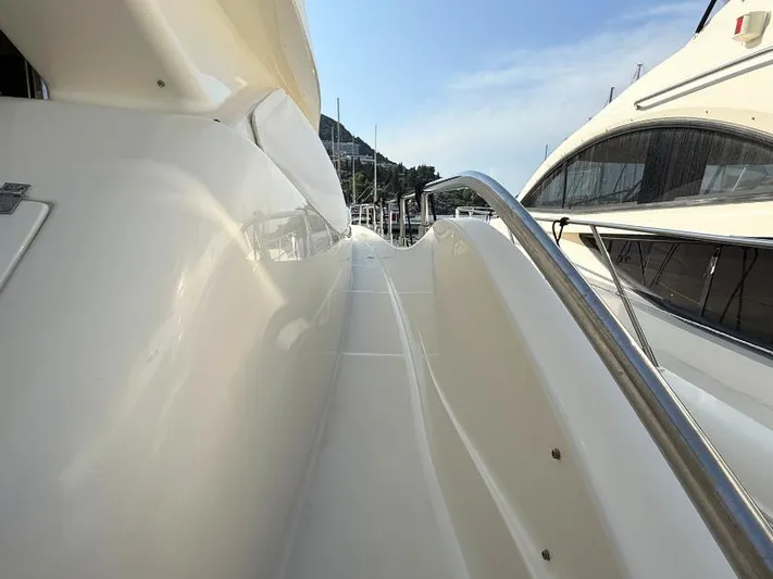  Yacht Photos Pics Side view of 2011 Ferretti Yachts 570, showcasing sleek design and polished railings.