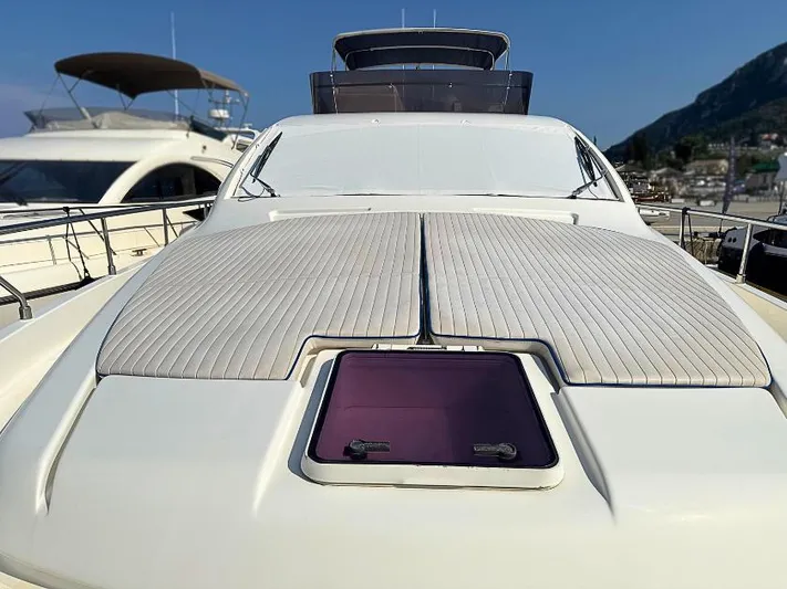  Yacht Photos Pics 2011 Ferretti Yachts 570 with sunbathing deck, docked in a marina under clear skies.