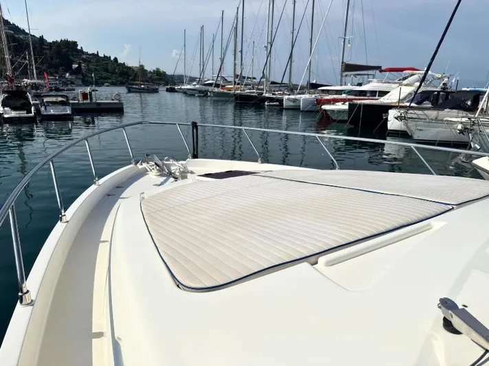  Yacht Photos Pics Ferretti Yachts 570, 2011 model, docked in a marina with other boats.