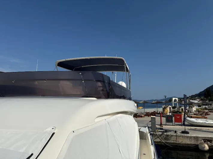  Yacht Photos Pics 2011 Ferretti Yachts 570 docked at a marina under clear blue skies.