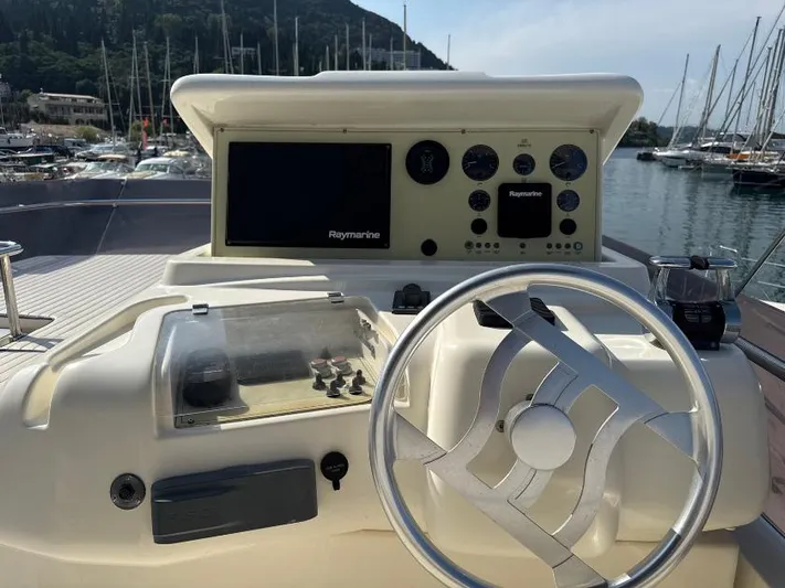  Yacht Photos Pics Helm of 2011 Ferretti Yachts 570 with Raymarine navigation system, docked in marina.