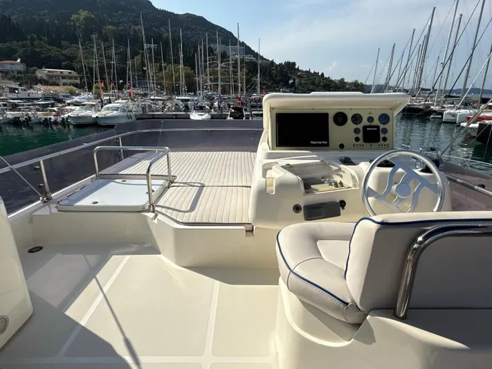  Yacht Photos Pics Flybridge of 2011 Ferretti Yachts 570 with helm station, overlooking marina and sailboats.