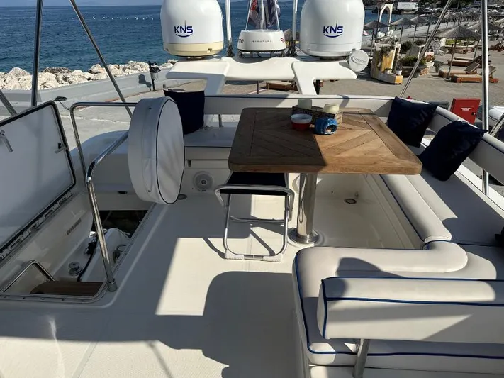  Yacht Photos Pics Luxurious 2011 Ferretti Yachts 570 deck with seating and table, overlooking the ocean.