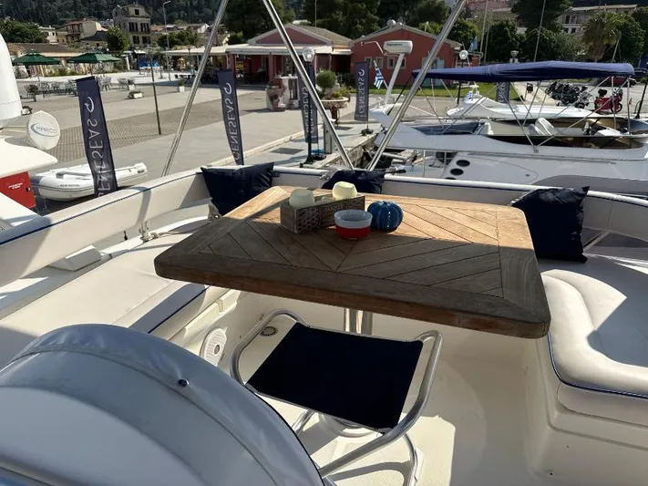  Yacht Photos Pics Luxurious 2011 Ferretti Yachts 570 deck with elegant seating and wooden table.