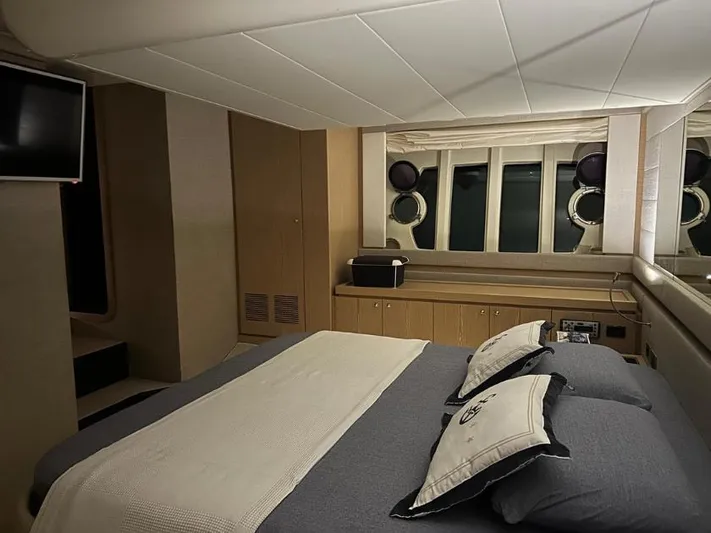  Yacht Photos Pics Luxurious bedroom interior of 2011 Ferretti Yachts 570 with modern decor and porthole windows.