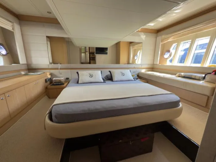  Yacht Photos Pics Luxurious bedroom interior of 2011 Ferretti Yachts 570 with elegant furnishings and ample natural light.