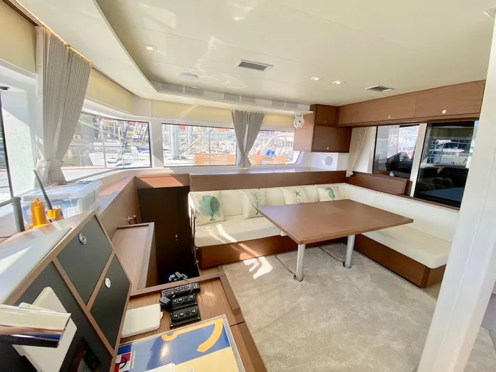 Tiga Yacht Photos Pics Luxurious interior of 2020 Lagoon 52 F yacht with modern seating and large windows.