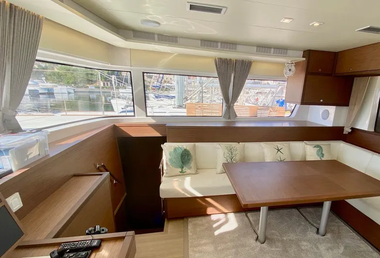 Tiga Yacht Photos Pics Interior of 2020 Lagoon 52 F yacht with modern seating and large windows.