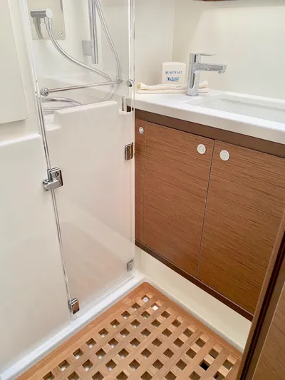 Tiga Yacht Photos Pics Modern bathroom in 2020 Lagoon 52 F yacht with wooden accents and glass shower.