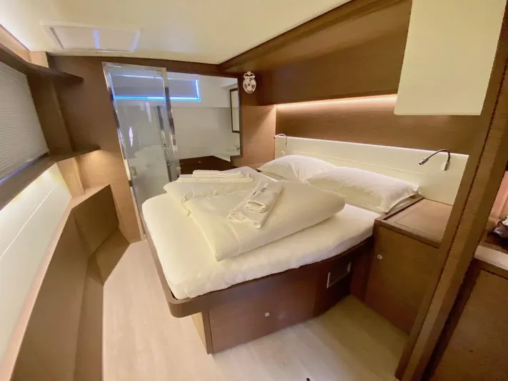Tiga Yacht Photos Pics Luxurious cabin interior of 2020 Lagoon 52 F yacht with cozy bed and modern design.