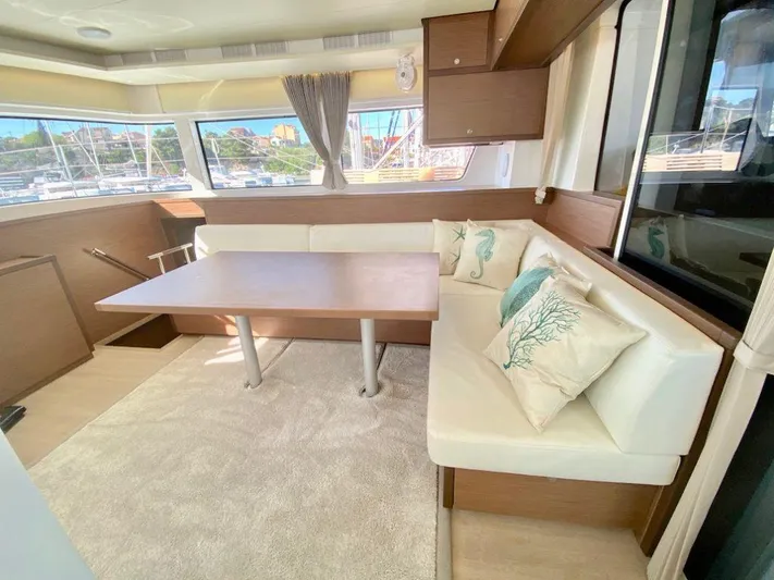 Tiga Yacht Photos Pics Interior of 2020 Lagoon 52 F yacht with elegant seating and dining area.