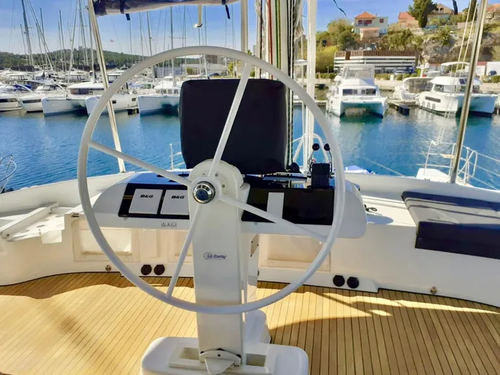 Tiga Yacht Photos Pics Helm of 2020 Lagoon 52 F catamaran in marina, featuring modern navigation equipment.