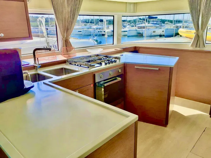Tiga Yacht Photos Pics Modern kitchen interior on 2020 Lagoon 52 F yacht with marina view.