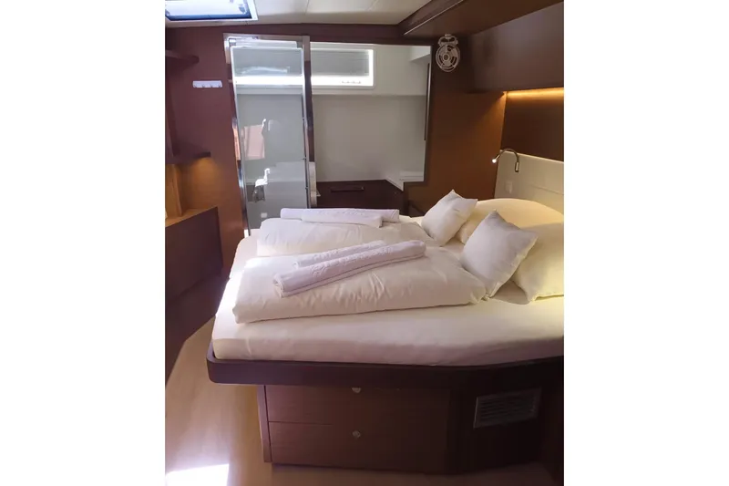 Tiga Yacht Photos Pics Luxurious cabin interior of 2020 Lagoon 52 F yacht with cozy bed and modern design.
