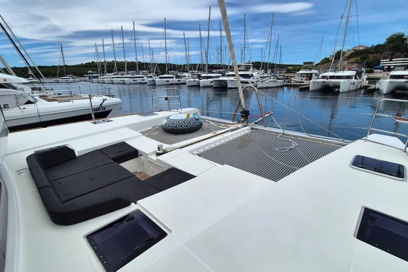Tiga Yacht Photos Pics 2020 Lagoon 52 F catamaran docked in a marina with other boats.