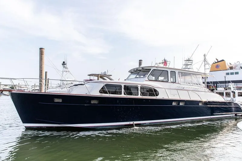 Marina Yacht Photos Pics 2008 Huckins Linwood yacht docked in marina, sleek design, white and navy exterior.