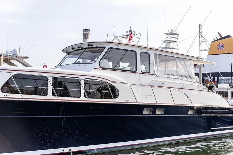 Marina Yacht Photos Pics 2008 Huckins Linwood yacht docked, featuring sleek design and elegant windows.