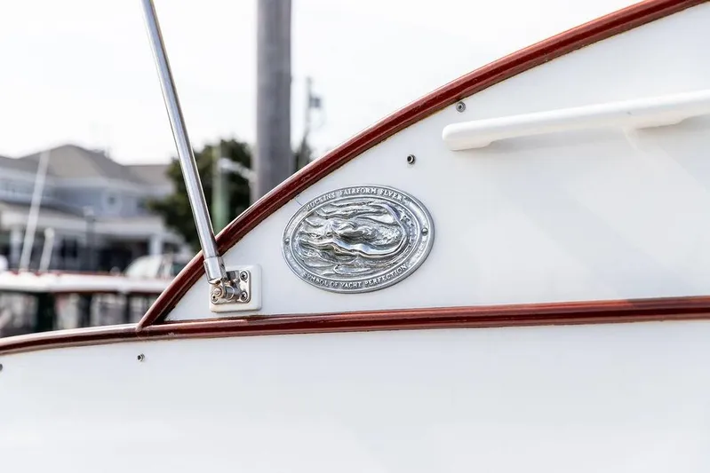 Marina Yacht Photos Pics 2008 Huckins Linwood boat emblem with polished metal detailing and wooden trim.