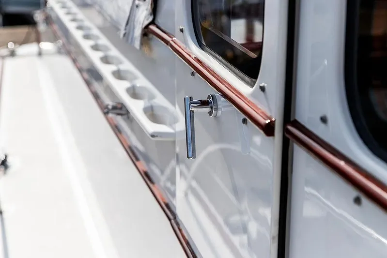 Marina Yacht Photos Pics Close-up of a 2008 Huckins Linwood boat handle and window detail.