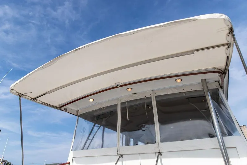 Marina Yacht Photos Pics 2008 Huckins Linwood boat canopy with clear panels under a blue sky.