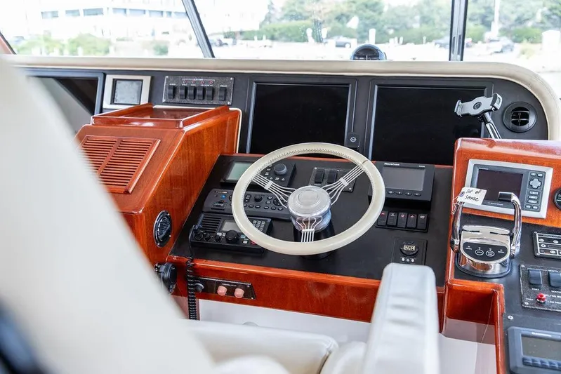 Marina Yacht Photos Pics 2008 Huckins Linwood yacht helm with modern navigation controls and wooden dashboard.