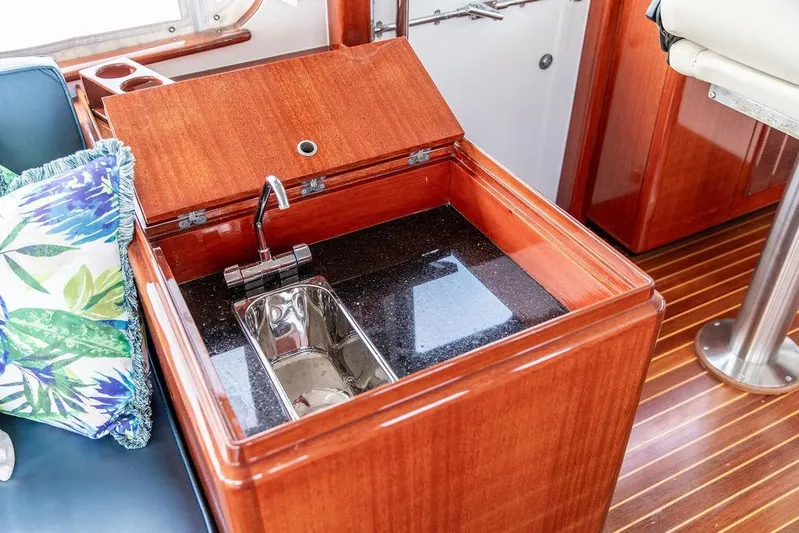 Marina Yacht Photos Pics Luxurious 2008 Huckins Linwood yacht interior with wooden cabinetry and built-in sink.