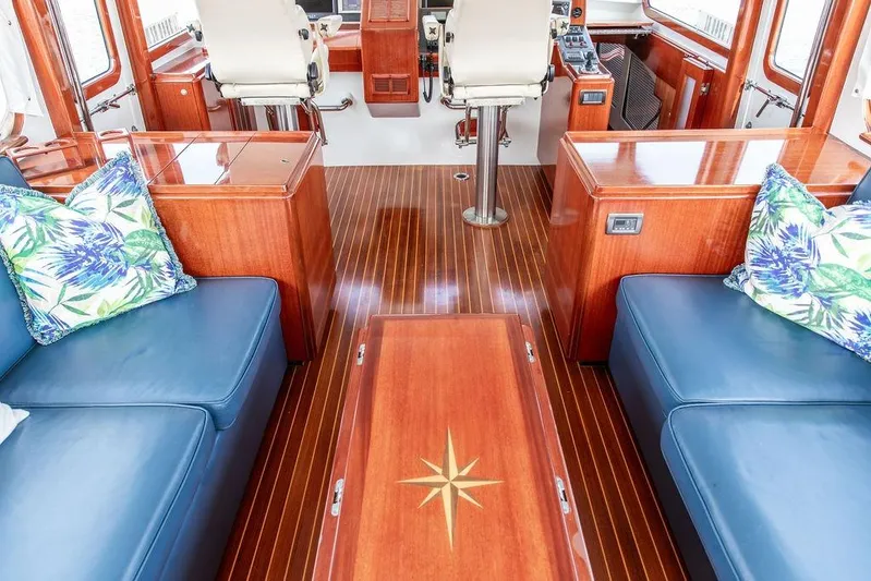 Marina Yacht Photos Pics Luxurious 2008 Huckins Linwood yacht interior with blue seating and elegant wood finishes.