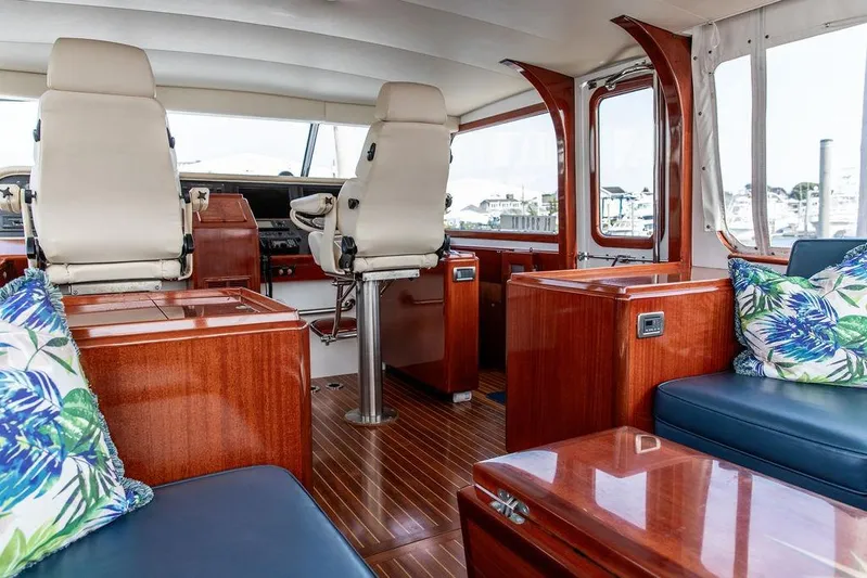 Marina Yacht Photos Pics Luxurious 2008 Huckins Linwood yacht interior with plush seating and elegant wood finishes.