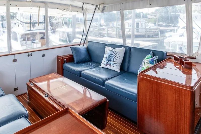 Marina Yacht Photos Pics Luxurious 2008 Huckins Linwood yacht interior with blue seating and wooden accents.