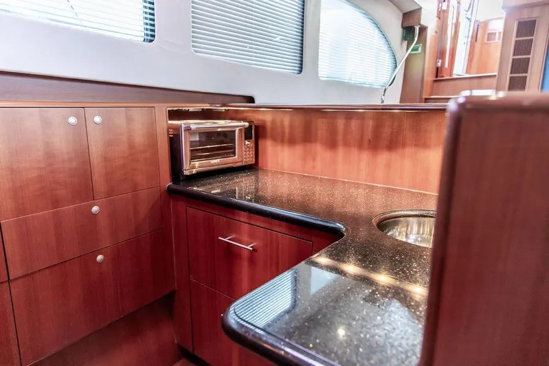 Marina Yacht Photos Pics Luxurious 2008 Huckins Linwood yacht interior with sleek wood cabinetry and modern appliances.