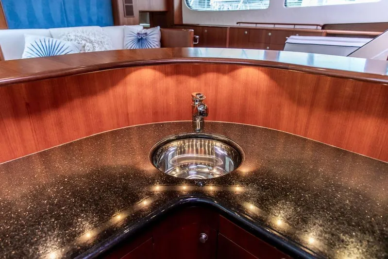Marina Yacht Photos Pics Luxurious 2008 Huckins Linwood yacht interior with elegant sink and polished wood finish.