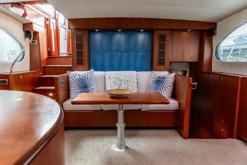 Marina Yacht Photos Pics Luxurious 2008 Huckins Linwood yacht interior with elegant wood finishes and cozy seating area.