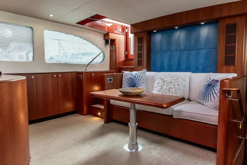 Marina Yacht Photos Pics Luxurious 2008 Huckins Linwood yacht interior with elegant wood paneling and plush seating.