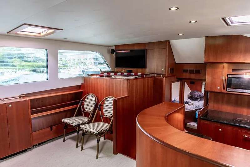 Marina Yacht Photos Pics Luxurious 2008 Huckins Linwood yacht interior with wood paneling, seating, and modern amenities.