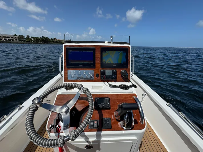  Yacht Photos Pics 2024 Dragonfly 21 Spanish Wells boat dashboard with navigation equipment on open water.