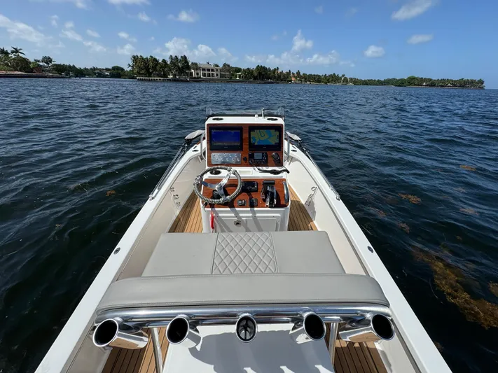  Yacht Photos Pics 2024 Dragonfly 21 Spanish Wells boat on water, featuring modern dashboard and steering wheel.