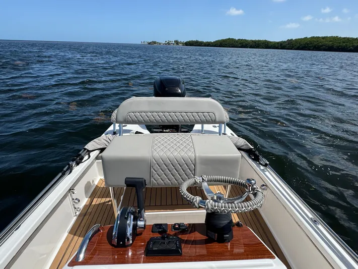  Yacht Photos Pics 2024 Dragonfly 21 Spanish Wells boat on open water, featuring elegant steering and seating.