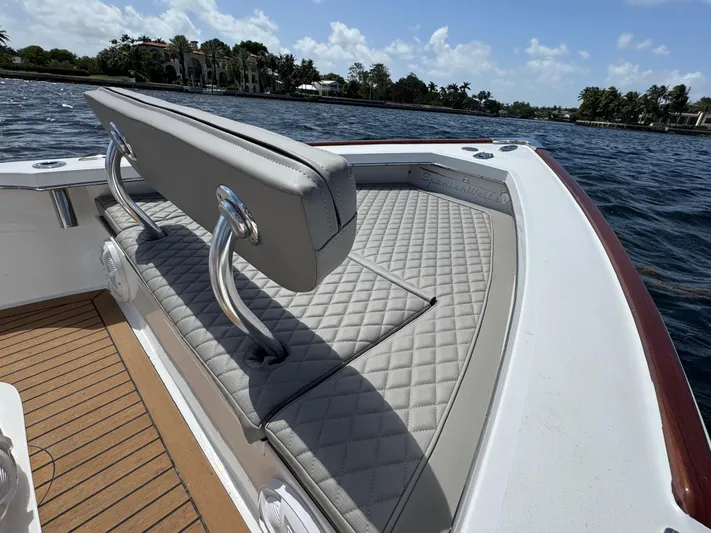  Yacht Photos Pics Luxury seating on 2024 Dragonfly 21 Spanish Wells boat, featuring quilted upholstery and scenic water view.