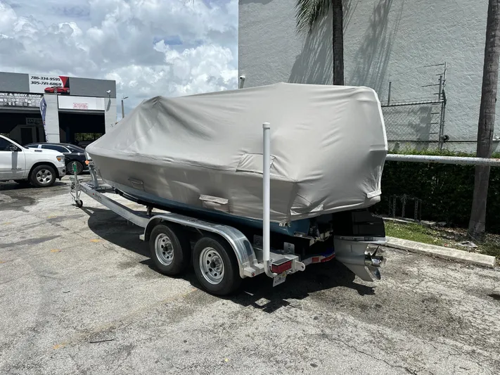  Yacht Photos Pics Covered 2024 Dragonfly 21 Spanish Wells boat on trailer in parking lot.