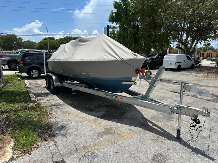  Yacht Photos Pics Covered 2024 Dragonfly 21 Spanish Wells boat on trailer in parking lot.