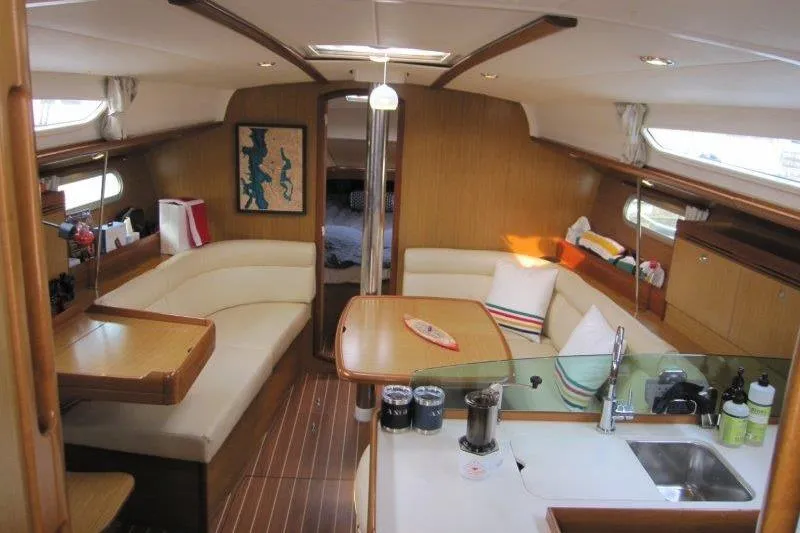 Angelucia Yacht Photos Pics Interior of 2008 Jeanneau Sun Odyssey 39i yacht with cozy seating and modern kitchen.