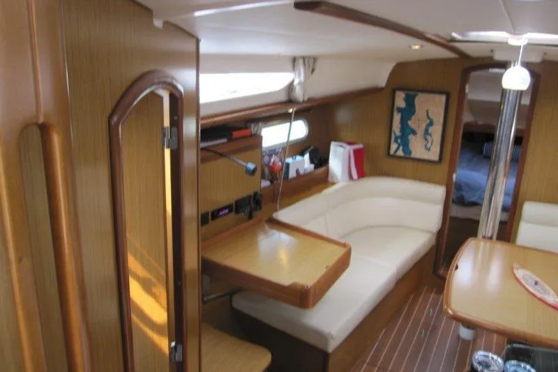 Angelucia Yacht Photos Pics Interior of 2008 Jeanneau Sun Odyssey 39i sailboat with wood finish and seating area.