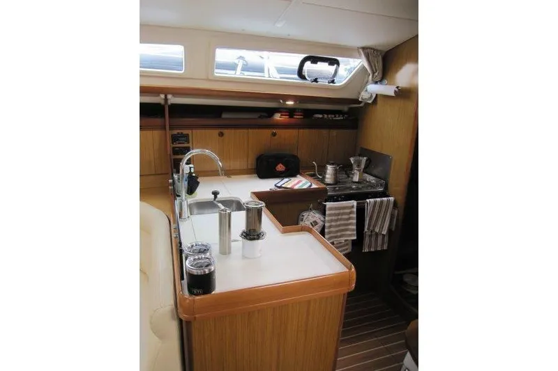 Angelucia Yacht Photos Pics Interior of 2008 Jeanneau Sun Odyssey 39i yacht, featuring a compact kitchen area.